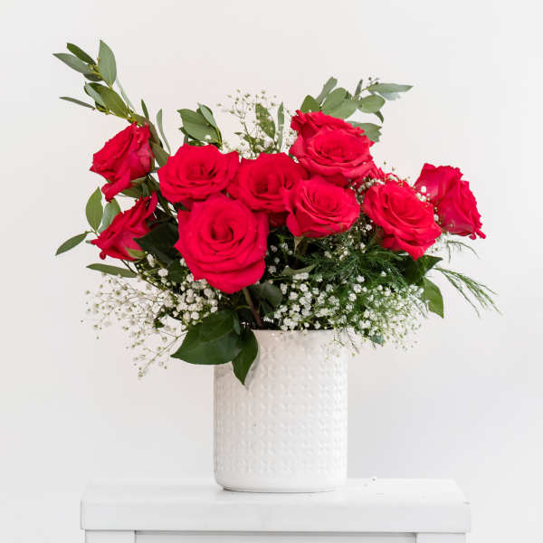 Bouquet of red roses in a white vase