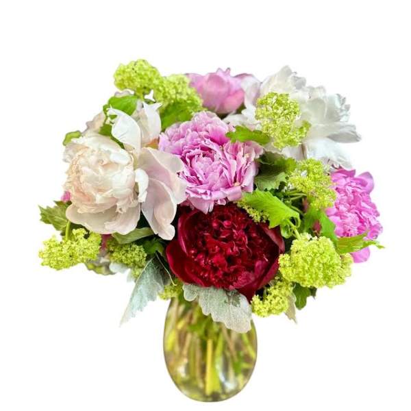 Bouquet of pink, white, and red flowers in a glass vase
