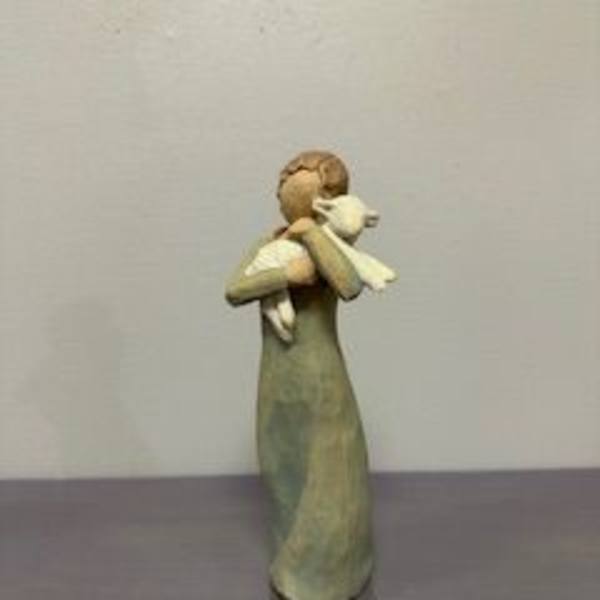 Small figurine of an angel holding a white bird