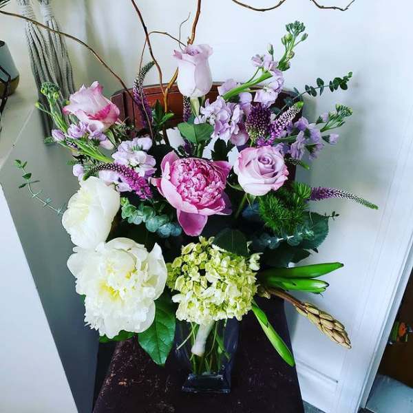 Mixed pink and white floral arrangement in a glass vase