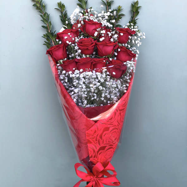 Bouquet of red roses with white baby's breath in red wrapping