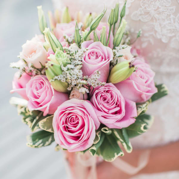 Pink rose bouquet with white filler flowers and green buds