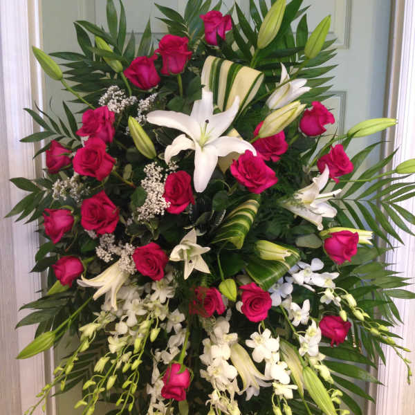 Standing spray of pink roses and white lilies with orchids