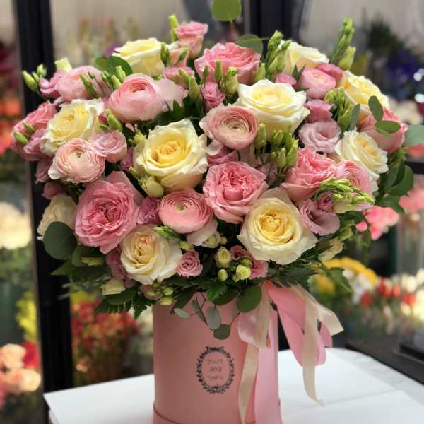 Pink and cream rose bouquet in a pink hatbox with ribbon