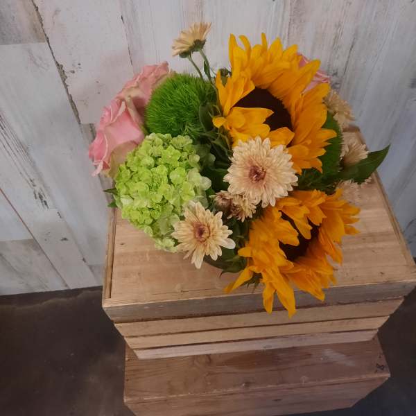 Bouquet with sunflowers, pink roses, and pale daisies