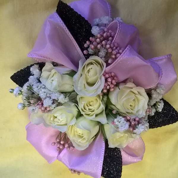 Bouquet of cream roses with pink and black ribbon accents