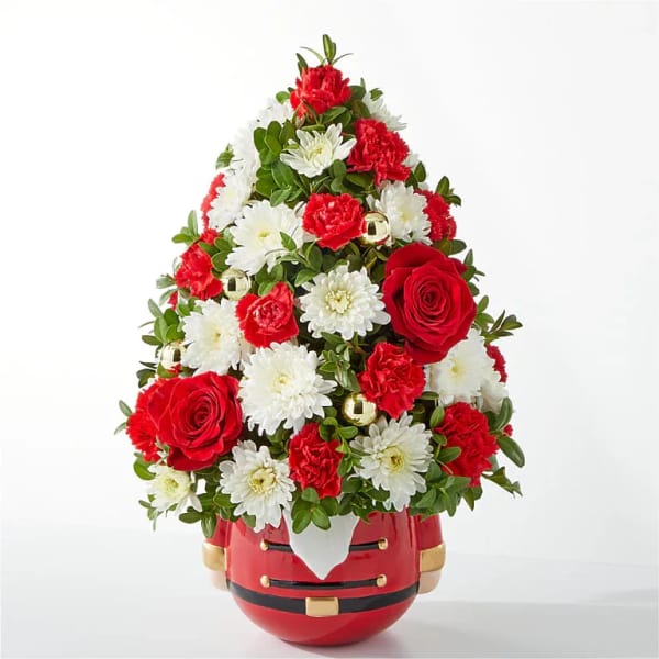 Red and white floral arrangement in a Santa-shaped container