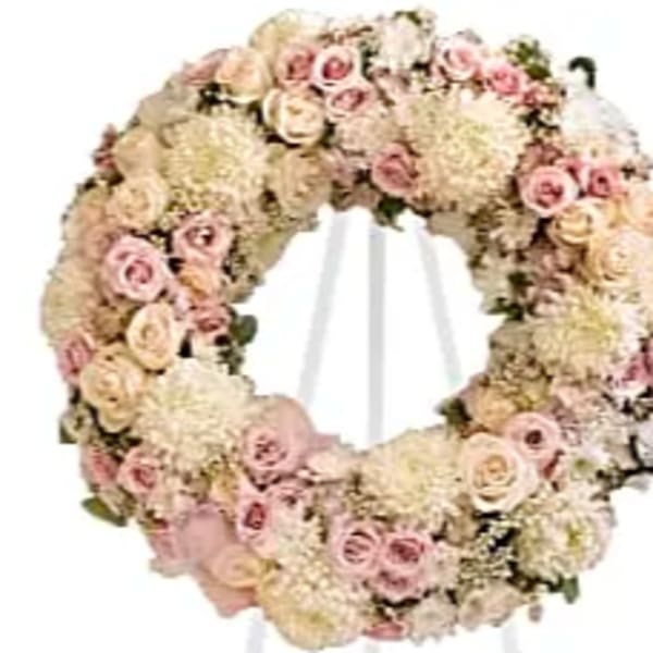 Round floral wreath of pale pink and cream roses