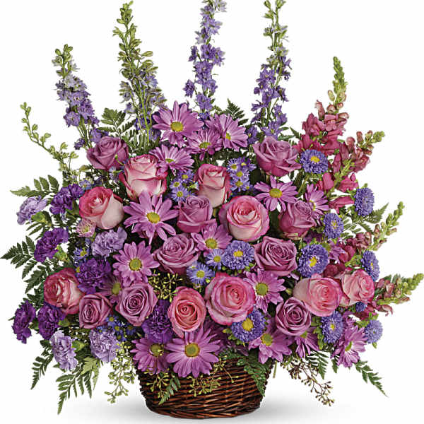 Basket arrangement of pink and purple roses with daisies and tall purple spikes