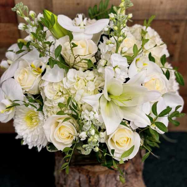 White floral bouquet with roses, lilies, and hydrangea
