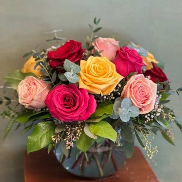 Bouquet of multicolored roses in a glass vase