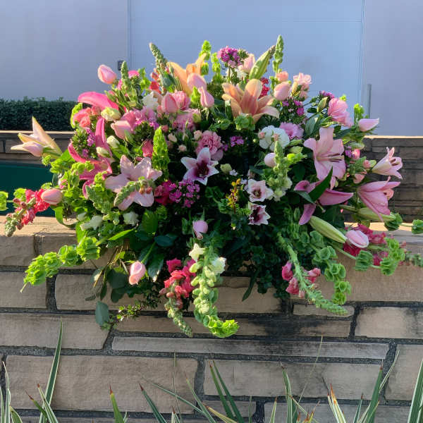 Large pink and peach floral arrangement with lilies and snapdragons