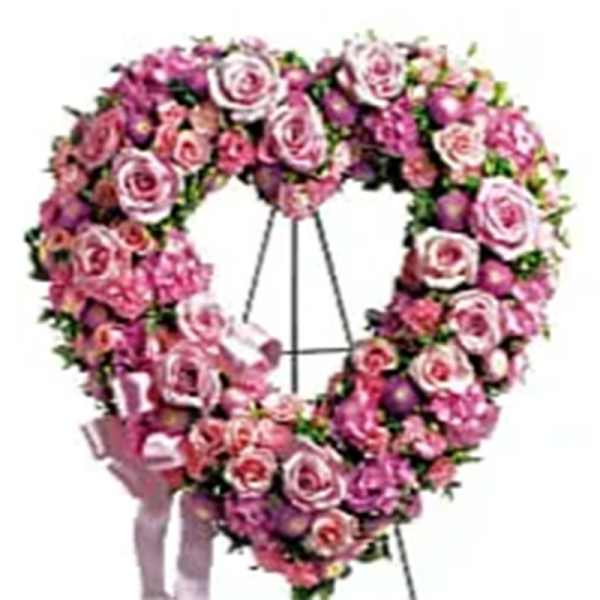 Heart-shaped standing wreath of pink roses on an easel