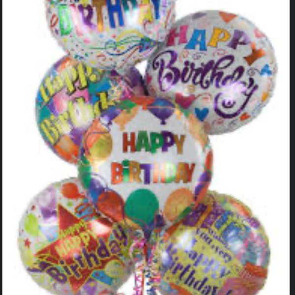 Cluster of colorful birthday balloons with printed messages