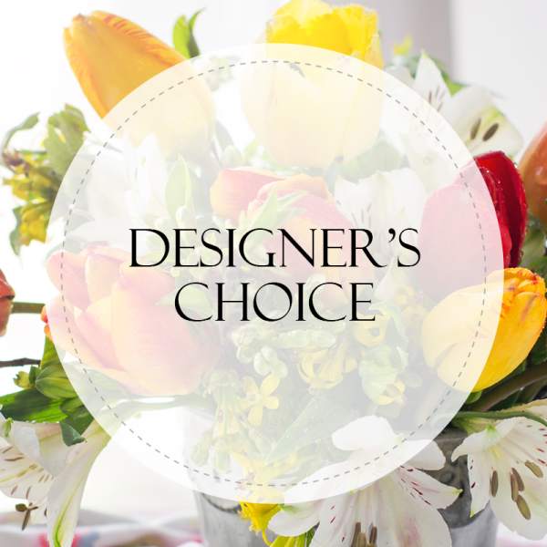 Mixed bouquet with roses and lilies overlaid by a "Designer’s Choice" label