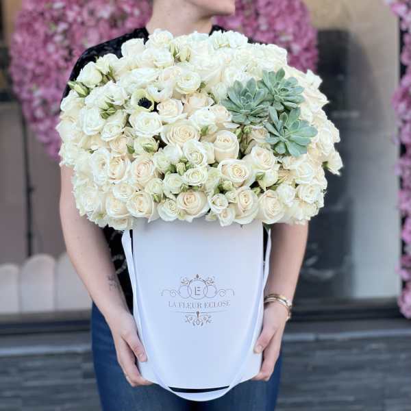 Large white rose bouquet in a white hat box with green succulents