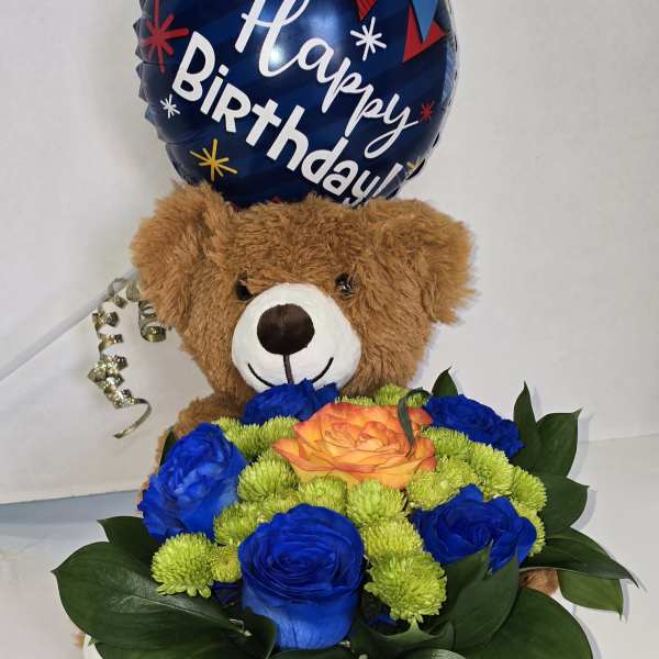 Birthday balloon above a teddy bear holding a basket of blue and orange flowers