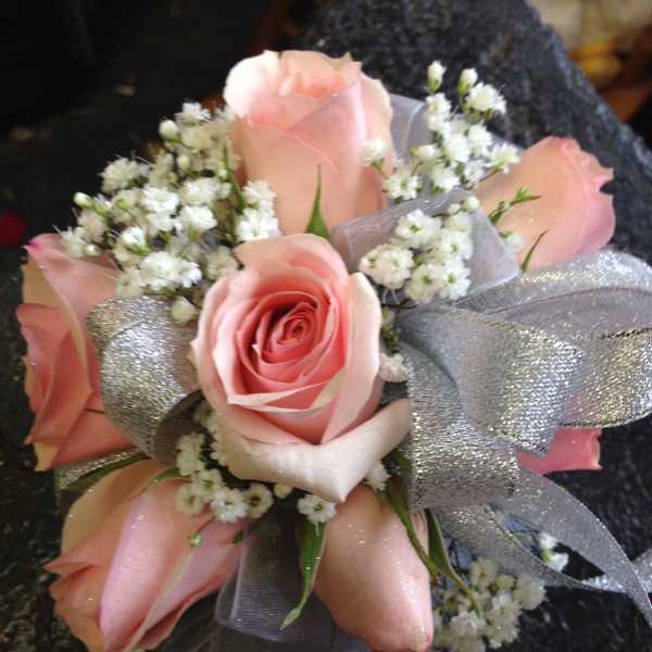Pink rose bouquet with white filler flowers and silver ribbon