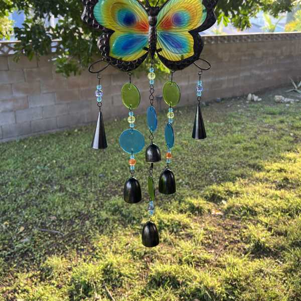 Colorful butterfly wind chime hanging outdoors