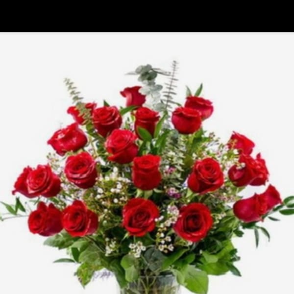 Red roses arranged in a clear glass vase