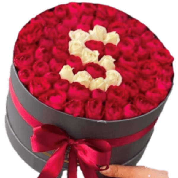 Round box filled with red and white roses arranged in a heart shape