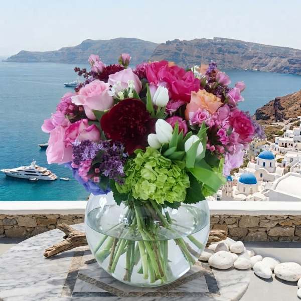 Mixed pink and white bouquet in a round glass vase