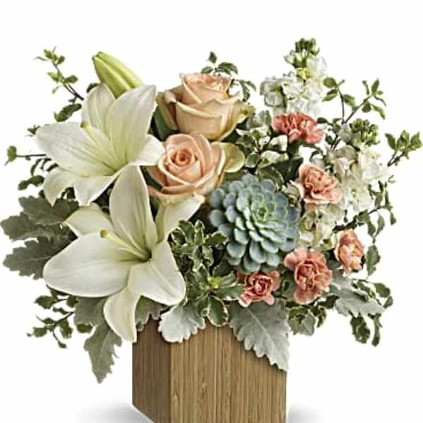 Arrangement of white lilies, peach roses, and carnations in a wooden box