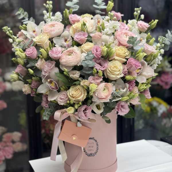 Pink and cream bouquet in a round pink box with ribbon