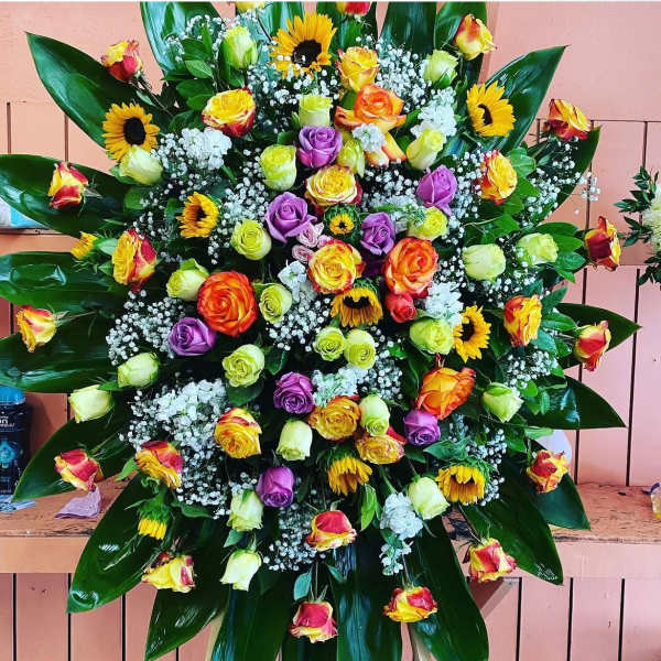 Large mixed bouquet with roses, sunflowers, and white filler flowers