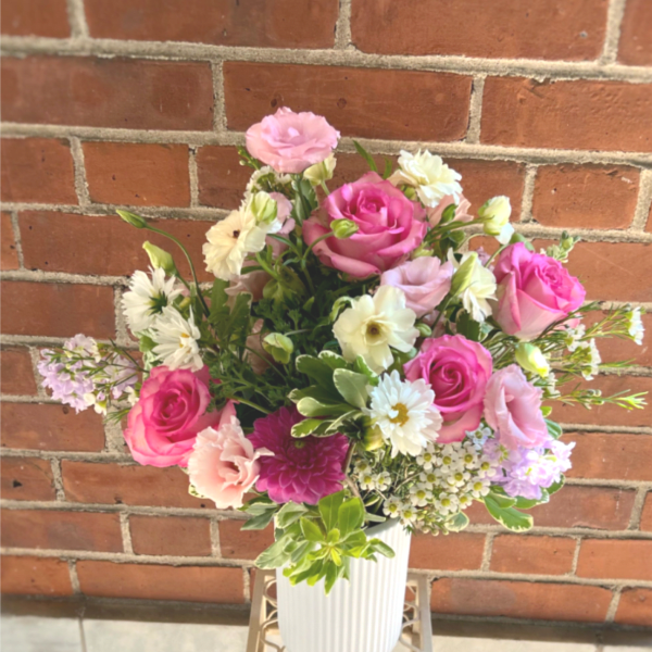 Pink and white mixed bouquet in a ribbed white vase