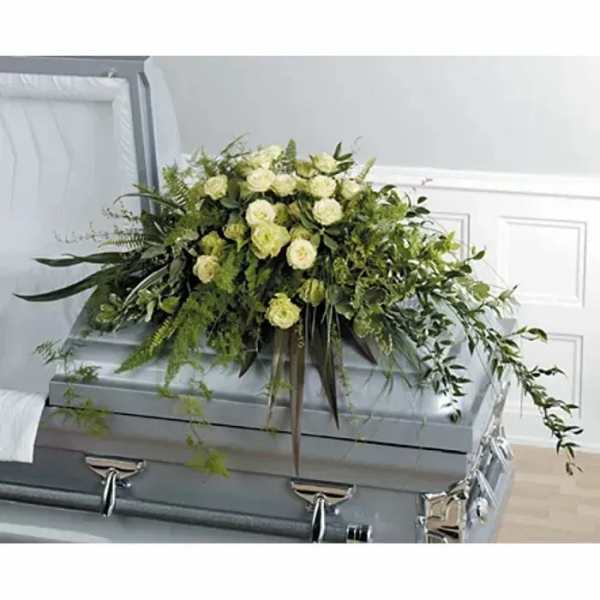 White rose casket spray with cascading greenery