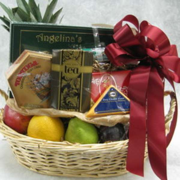 Gift basket with tea, fruit, and a red ribbon bow