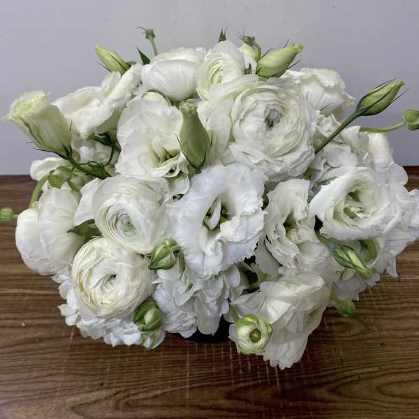 White floral bouquet with layered blooms and green buds
