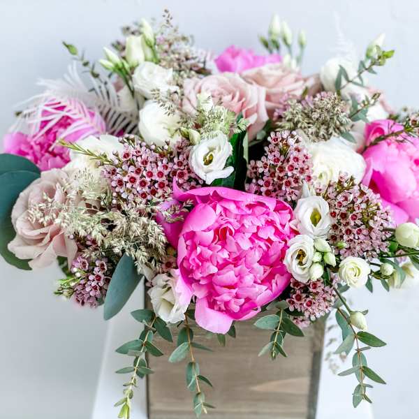 Pink and white mixed bouquet in a square vase