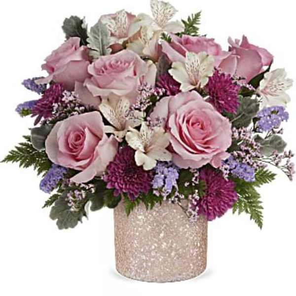 Pink roses and purple flowers arranged in a glittery vase