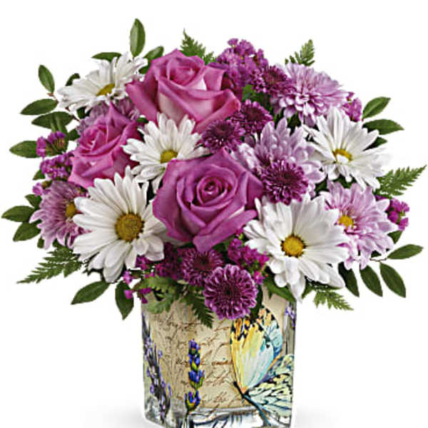 Pink roses and white daisies in a decorative square vase