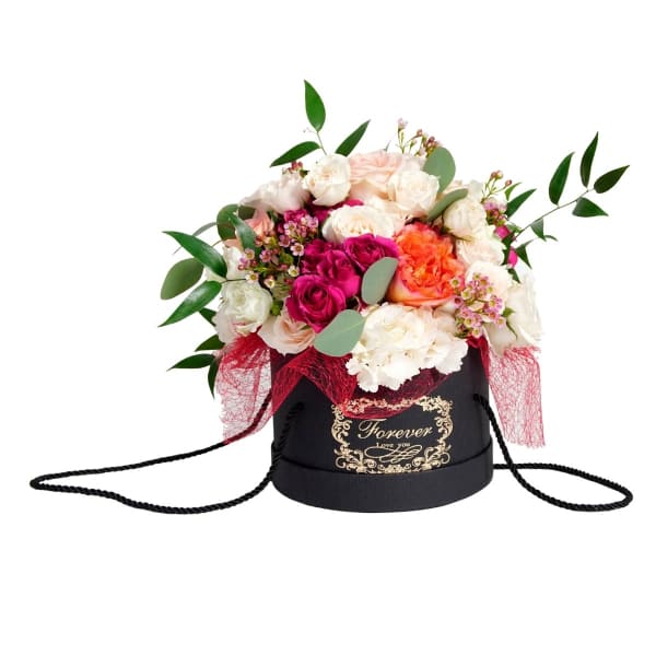 Mixed roses and hydrangeas in a black hatbox with a ribbon