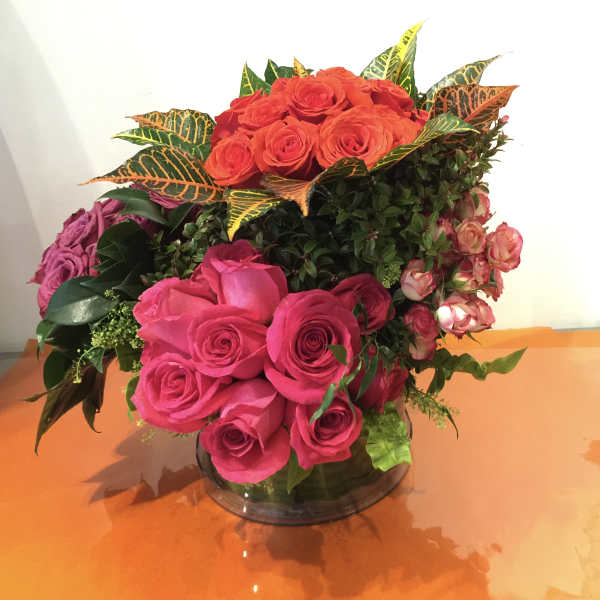 Bouquet of pink and orange roses in a glass vase
