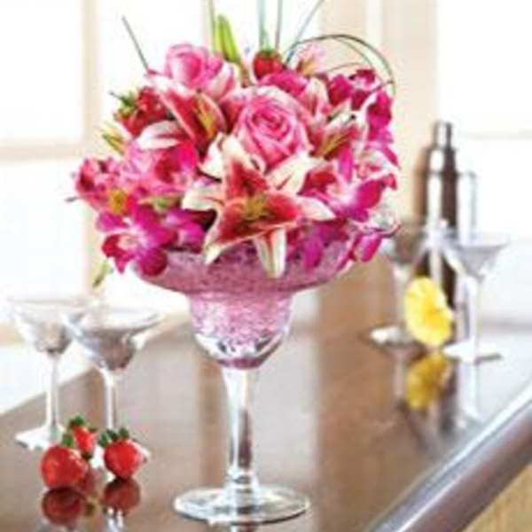 Pink and white floral arrangement in a tall glass goblet
