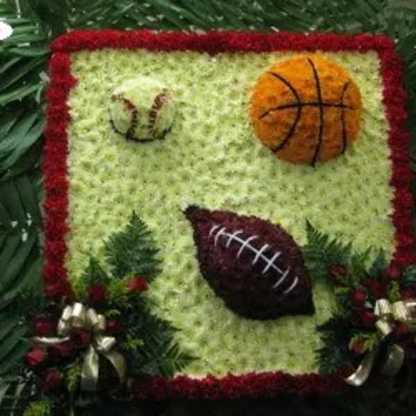 Floral sports-themed arrangement with basketball and football designs