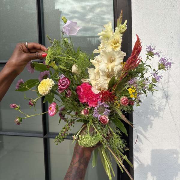 Loose bouquet of mixed pink, cream, and purple flowers