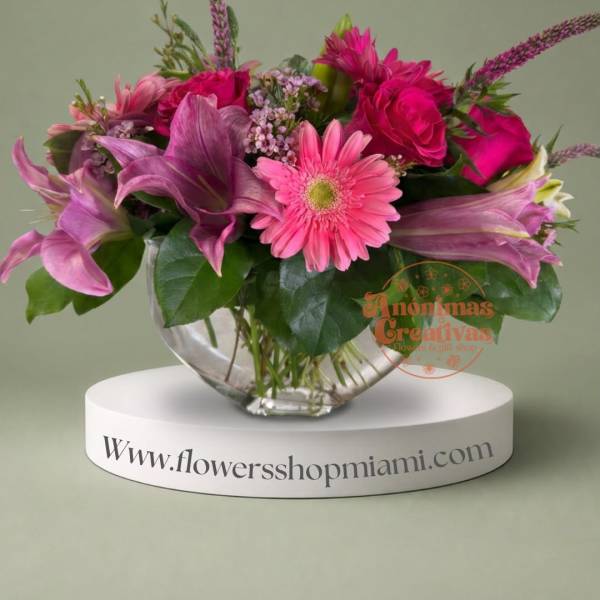 Pink and purple mixed bouquet in a clear glass bowl vase