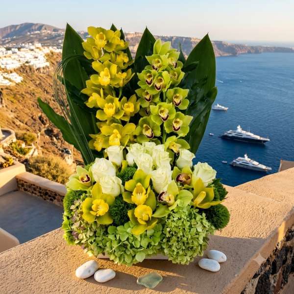 Yellow and white orchid arrangement in a low container