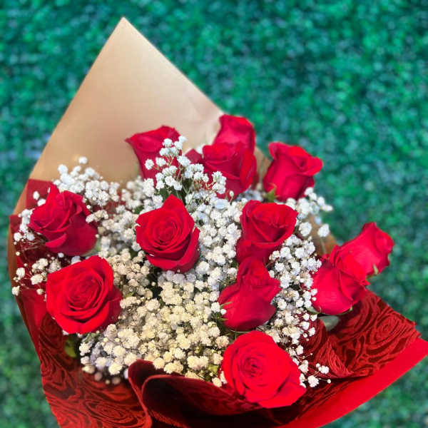 Bouquet of red roses with white baby's breath in red and tan wrap