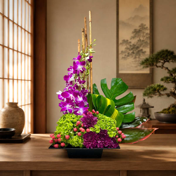 Purple orchids and green hydrangeas arranged in a black vase