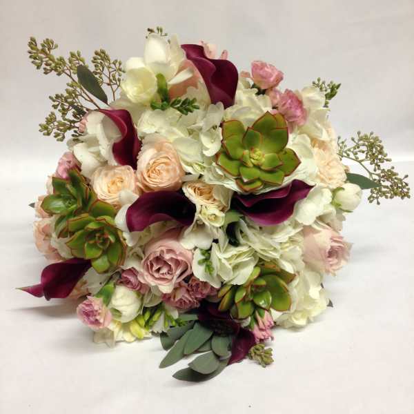 Bouquet of white and blush flowers with burgundy calla lilies and succulents