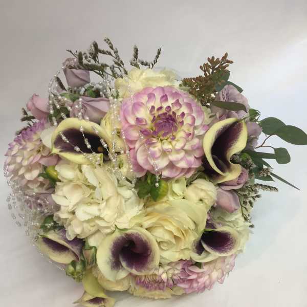 Bouquet of cream, pink, and purple flowers with pearl strands