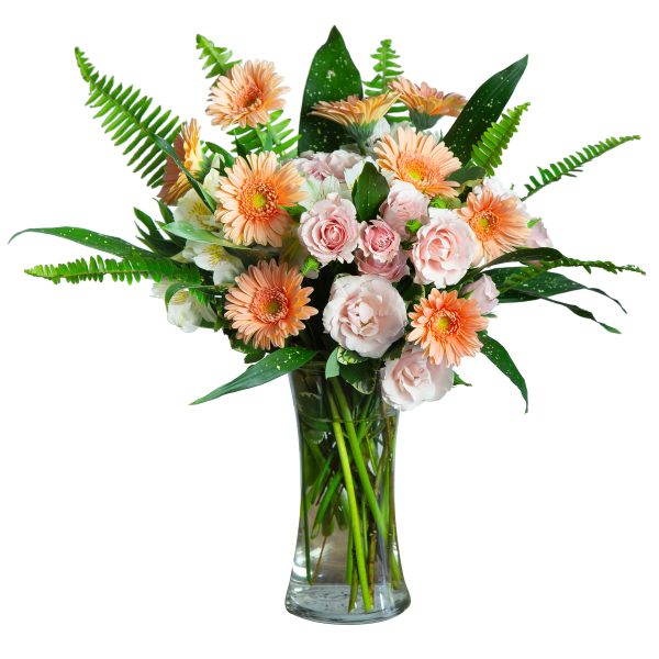 Peach gerbera daisies and pale pink roses in a clear glass vase