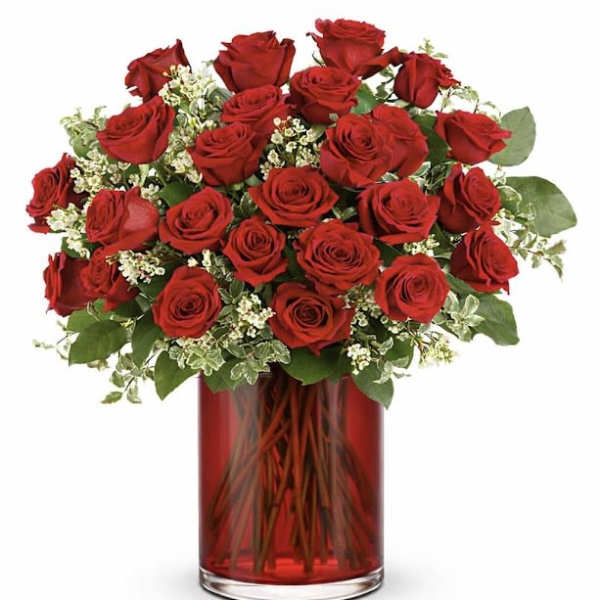 Red roses arranged in a red glass vase