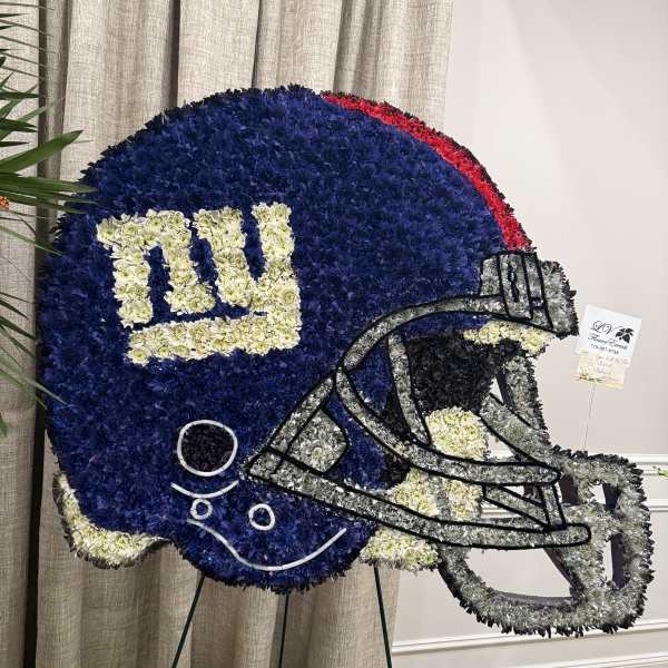 Football-shaped floral tribute in blue, white, gray, and red